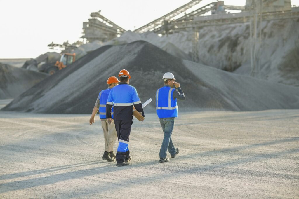 Workers in safety gear at a construction site.